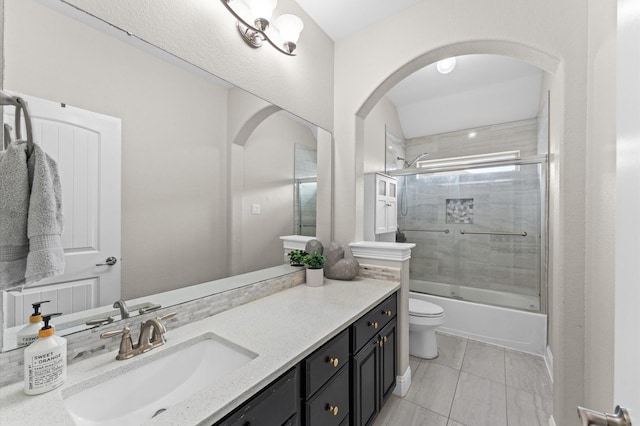 full bathroom with vanity, tile patterned floors, toilet, and shower / bath combination with glass door