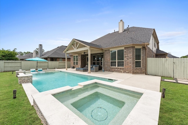 view of pool with a yard, ceiling fan, outdoor lounge area, and a patio area