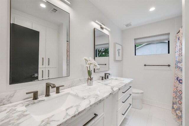 full bathroom with toilet, visible vents, and a sink