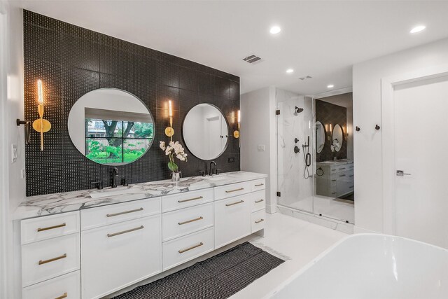 full bath with double vanity, a stall shower, recessed lighting, and visible vents