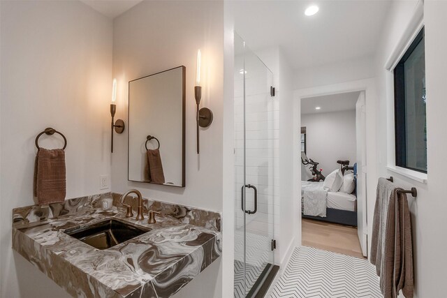 ensuite bathroom featuring a sink, a stall shower, recessed lighting, and connected bathroom