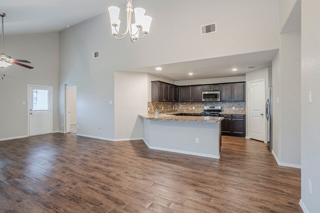 kitchen featuring dark brown cabinetry, high vaulted ceiling, stainless steel appliances, open floor plan, and visible vents