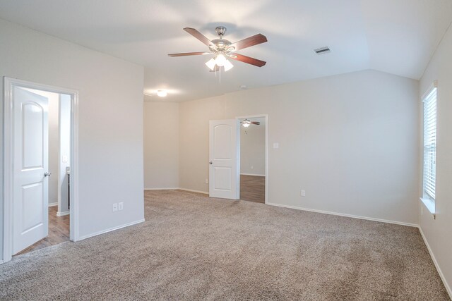 15459 Refugio Verde Way, Houston, TX 77049 - unfurnished bedroom with visible vents, baseboards, lofted ceiling, and light carpet