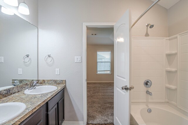 full bathroom with a sink, washtub / shower combination, and double vanity