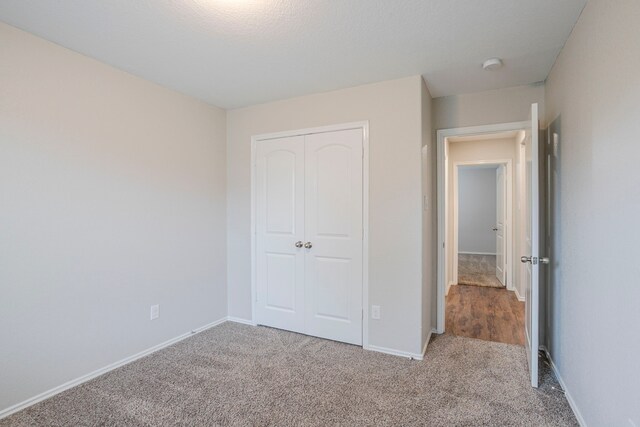 15459 Refugio Verde Way, Houston, TX 77049 - unfurnished bedroom featuring baseboards, carpet flooring, and a closet