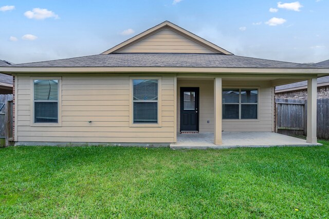 15459 Refugio Verde Way, Houston, TX 77049 - rear view of house featuring a yard, fence, a patio, and a shingled roof