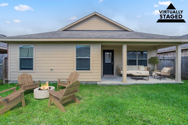 15459 Refugio Verde Way, Houston, TX 77049 - back of house featuring roof with shingles, fence, a patio, a lawn, and an outdoor living space with a fire pit