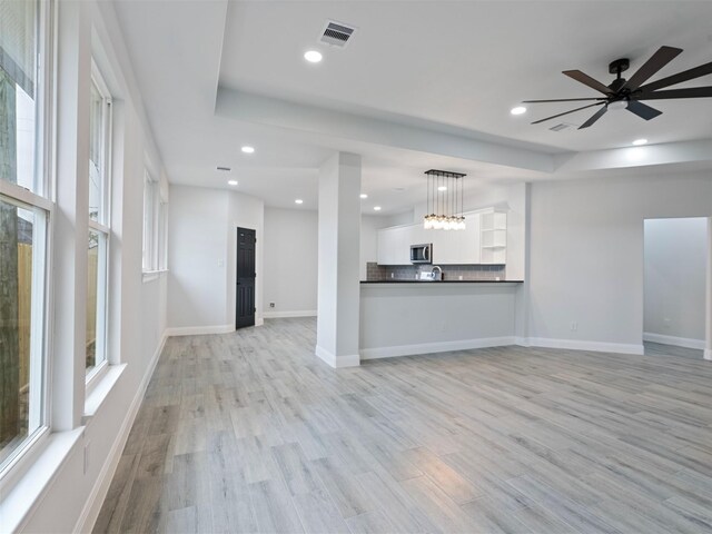 unfurnished living room featuring light wood-type flooring, recessed lighting, ceiling fan, and visible vents