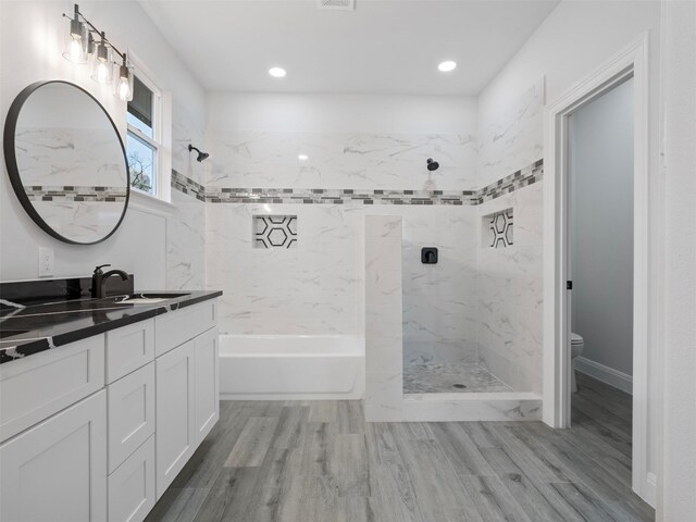 full bathroom with vanity, recessed lighting, wood finished floors, and toilet