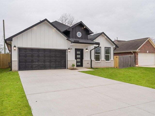 modern inspired farmhouse featuring board and batten siding, brick siding, an attached garage, and fence