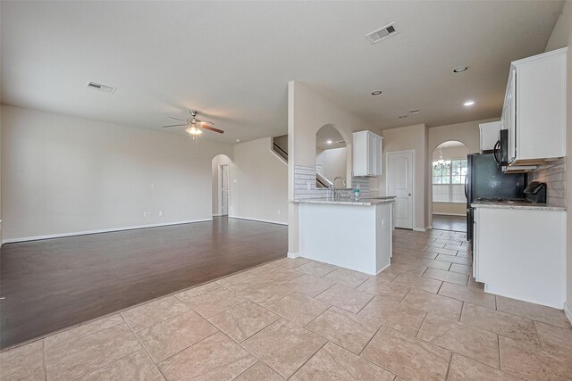 25451 Dappled Filly Dr, Tomball, TX 77375 - kitchen with arched walkways, a ceiling fan, and visible vents