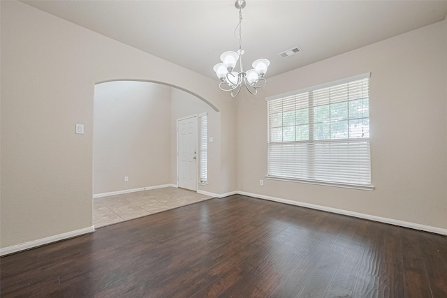 25451 Dappled Filly Dr, Tomball, TX 77375 - spare room featuring arched walkways, a chandelier, baseboards, wood finished floors, and visible vents
