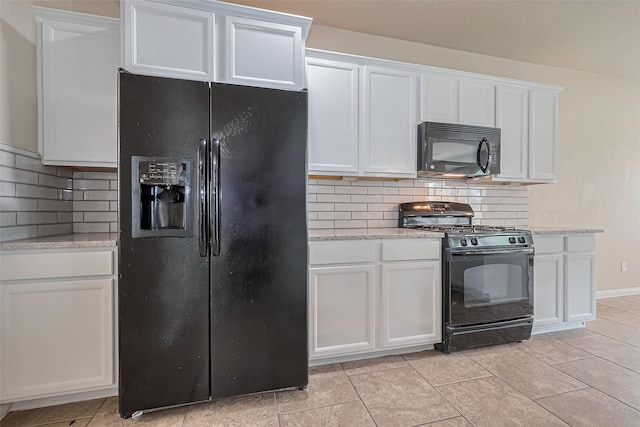25451 Dappled Filly Dr, Tomball, TX 77375 - kitchen with white cabinets, black appliances, and tasteful backsplash