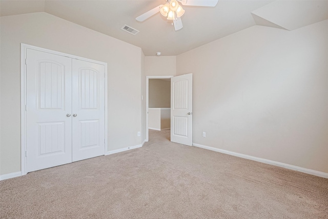 25451 Dappled Filly Dr, Tomball, TX 77375 - unfurnished bedroom with light colored carpet, visible vents, vaulted ceiling, baseboards, and a closet