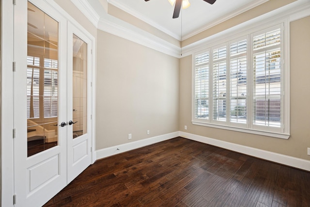 unfurnished room with crown molding, dark wood-type flooring, baseboards, and ceiling fan