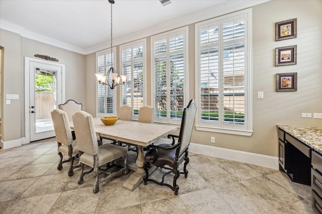 dining room featuring crown molding, baseboards, and a chandelier