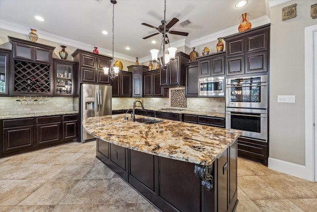 kitchen featuring a ceiling fan, backsplash, crown molding, a sink, and stainless steel appliances