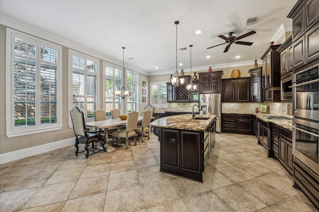 kitchen with light stone countertops, baseboards, backsplash, visible vents, and ornamental molding