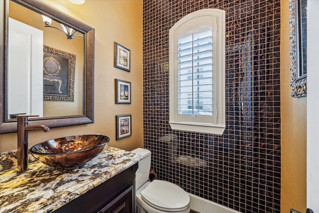 half bath with vanity and toilet