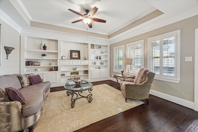 living room with dark wood-style flooring, a ceiling fan, baseboards, and ornamental molding