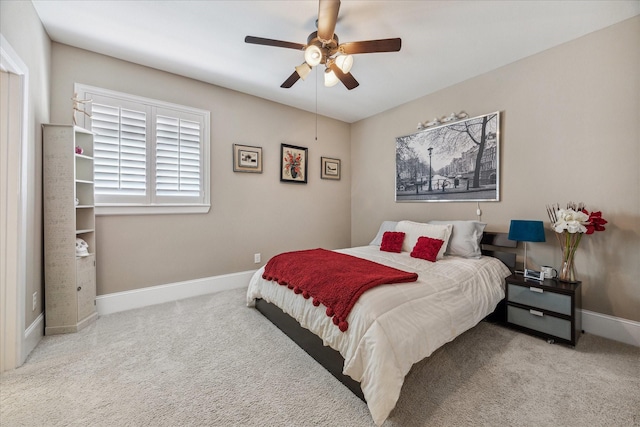 bedroom featuring baseboards, a ceiling fan, and carpet