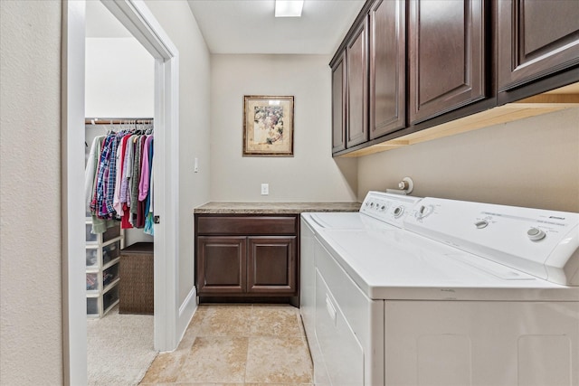 clothes washing area featuring cabinet space and washing machine and clothes dryer