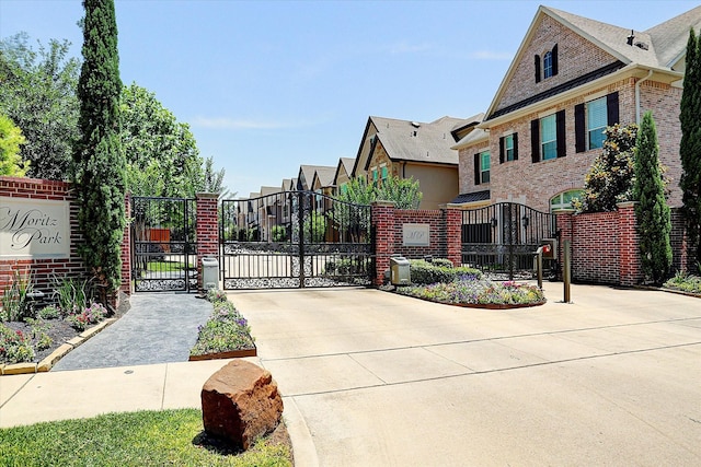view of gate with fence and a residential view