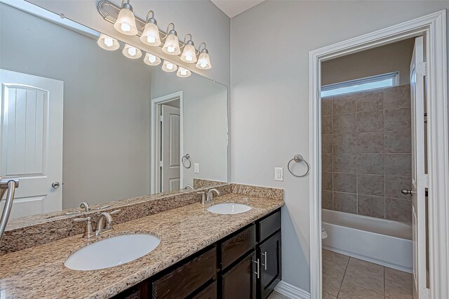 full bathroom with tile patterned flooring, a sink, baseboards, and double vanity