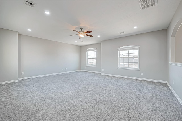 carpeted spare room with a ceiling fan, visible vents, and recessed lighting