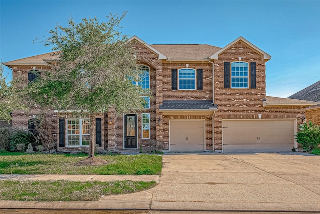 view of front of home featuring roof with shingles, an attached garage, concrete driveway, and brick siding