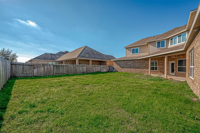 view of yard with a fenced backyard
