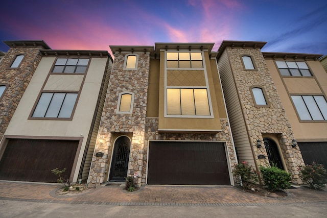 5341 Nolda St Unit E, Houston, TX 77007 - multi unit property featuring an attached garage, stucco siding, and decorative driveway