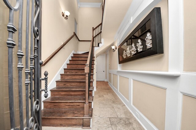5341 Nolda St Unit E, Houston, TX 77007 - entrance foyer featuring stone tile floors, stairs, and crown molding