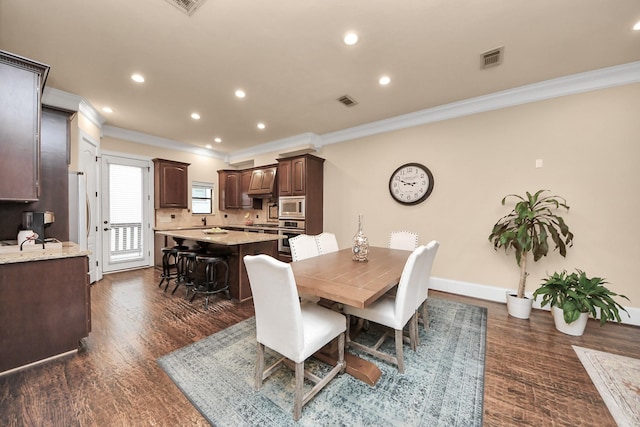 5341 Nolda St Unit E, Houston, TX 77007 - dining room featuring dark wood-style flooring, ornamental molding, recessed lighting, and visible vents