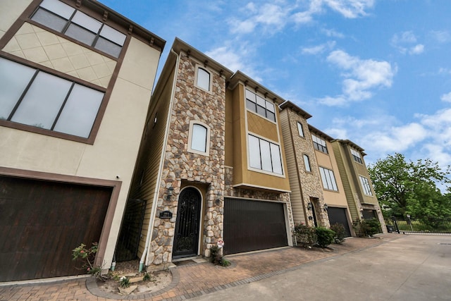 5341 Nolda St Unit E, Houston, TX 77007 - view of property featuring driveway, fence, and a garage