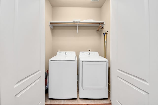 5341 Nolda St Unit E, Houston, TX 77007 - washroom featuring light tile patterned floors, laundry area, visible vents, and washer and clothes dryer