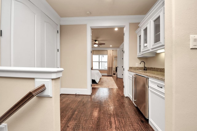 5341 Nolda St Unit E, Houston, TX 77007 - kitchen featuring glass insert cabinets, fridge, dark wood finished floors, ceiling fan, and white cabinetry