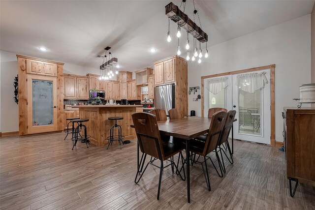 dining space featuring light wood-type flooring, recessed lighting, baseboards, and french doors
