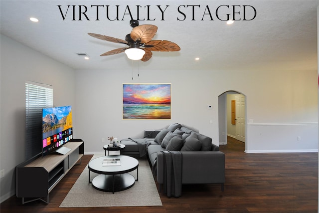 living area with arched walkways, a ceiling fan, baseboards, recessed lighting, and wood finished floors