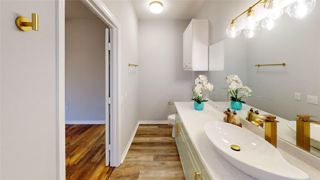 9267 Inlet Cir, Montgomery, TX 77356 - bathroom with wood finished floors, toilet, vanity, and baseboards