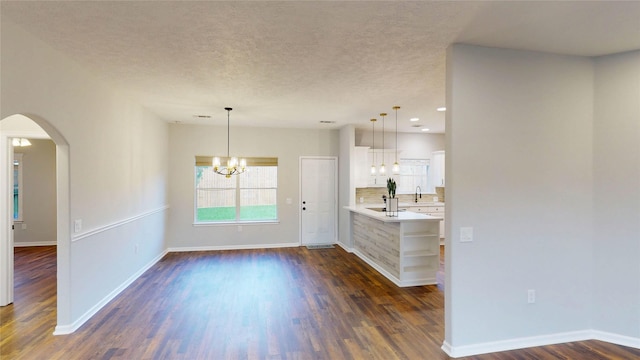 9267 Inlet Cir, Montgomery, TX 77356 - kitchen with light countertops, a chandelier, white cabinetry, dark wood-style flooring, and baseboards