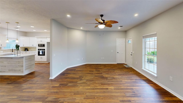 9267 Inlet Cir, Montgomery, TX 77356 - unfurnished living room with ceiling fan, a sink, dark wood-type flooring, baseboards, and recessed lighting