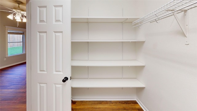 9267 Inlet Cir, Montgomery, TX 77356 - walk in closet with ceiling fan and wood finished floors