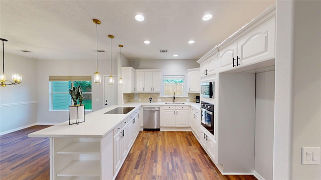 9267 Inlet Cir, Montgomery, TX 77356 - kitchen with a sink, a peninsula, open shelves, wall oven, and black electric stovetop