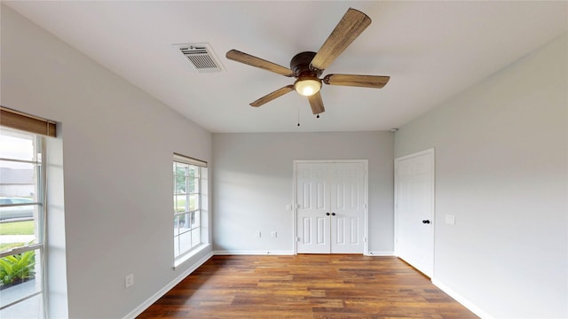 9267 Inlet Cir, Montgomery, TX 77356 - unfurnished bedroom with wood finished floors, baseboards, and a ceiling fan