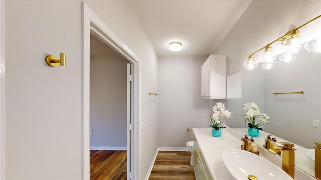 9267 Inlet Cir, Montgomery, TX 77356 - half bathroom with wood finished floors, toilet, vanity, and baseboards