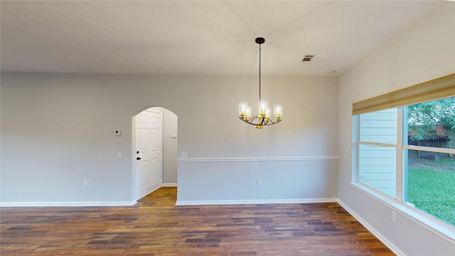 9267 Inlet Cir, Montgomery, TX 77356 - empty room with dark wood-type flooring, arched walkways, a chandelier, and baseboards
