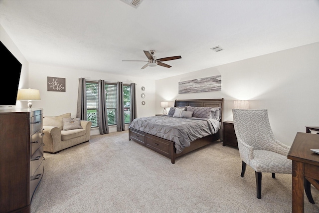bedroom featuring light carpet, a ceiling fan, and visible vents