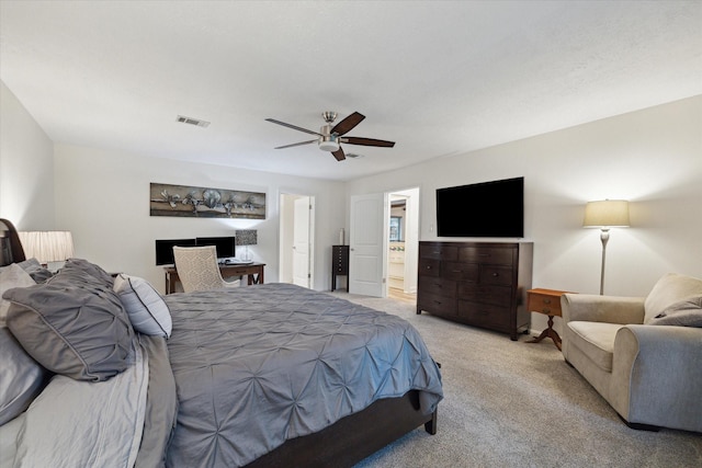 bedroom featuring ensuite bathroom, ceiling fan, light carpet, and visible vents