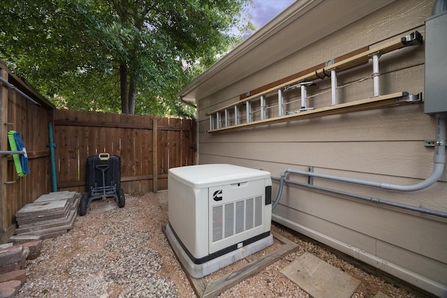 details featuring fence and a power unit